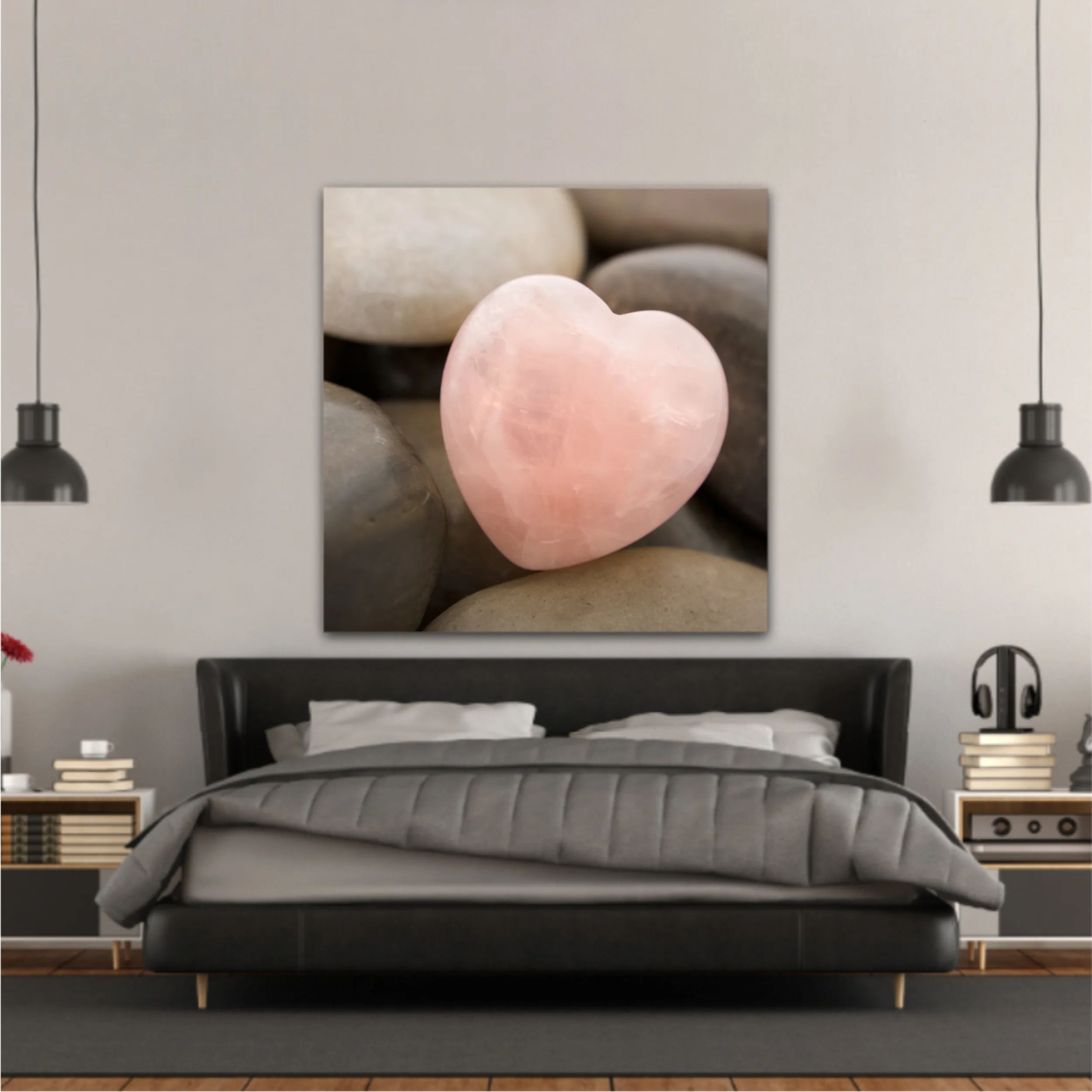 Rose quartz heart on pebbles